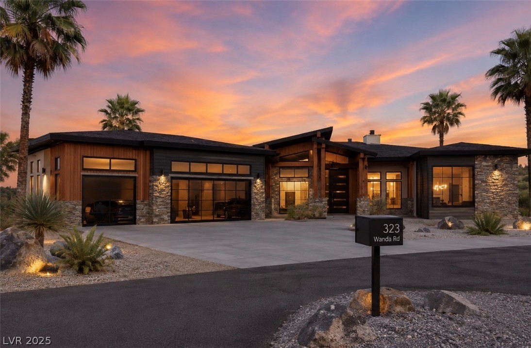 323 Wanda Road Henderson, NV 89002 - Photo 1 of 4 Architectural splendor meets desert flora under a captivating sunset sky.