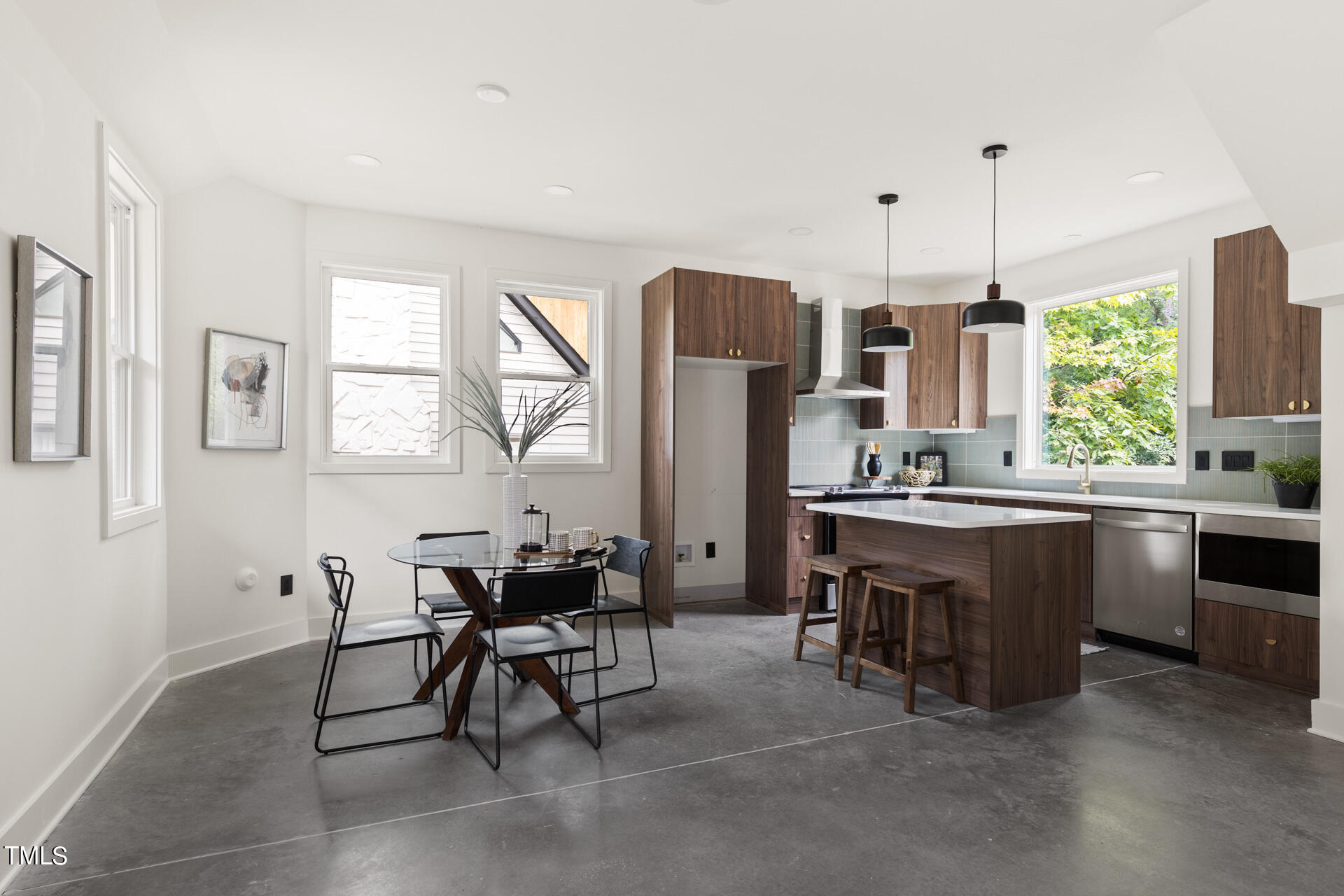 2909 Herring Boulevard Durham, NC 27704 - Photo 21 of 47 a kitchen with stainless steel appliances kitchen island granite countertop furniture and a dining table