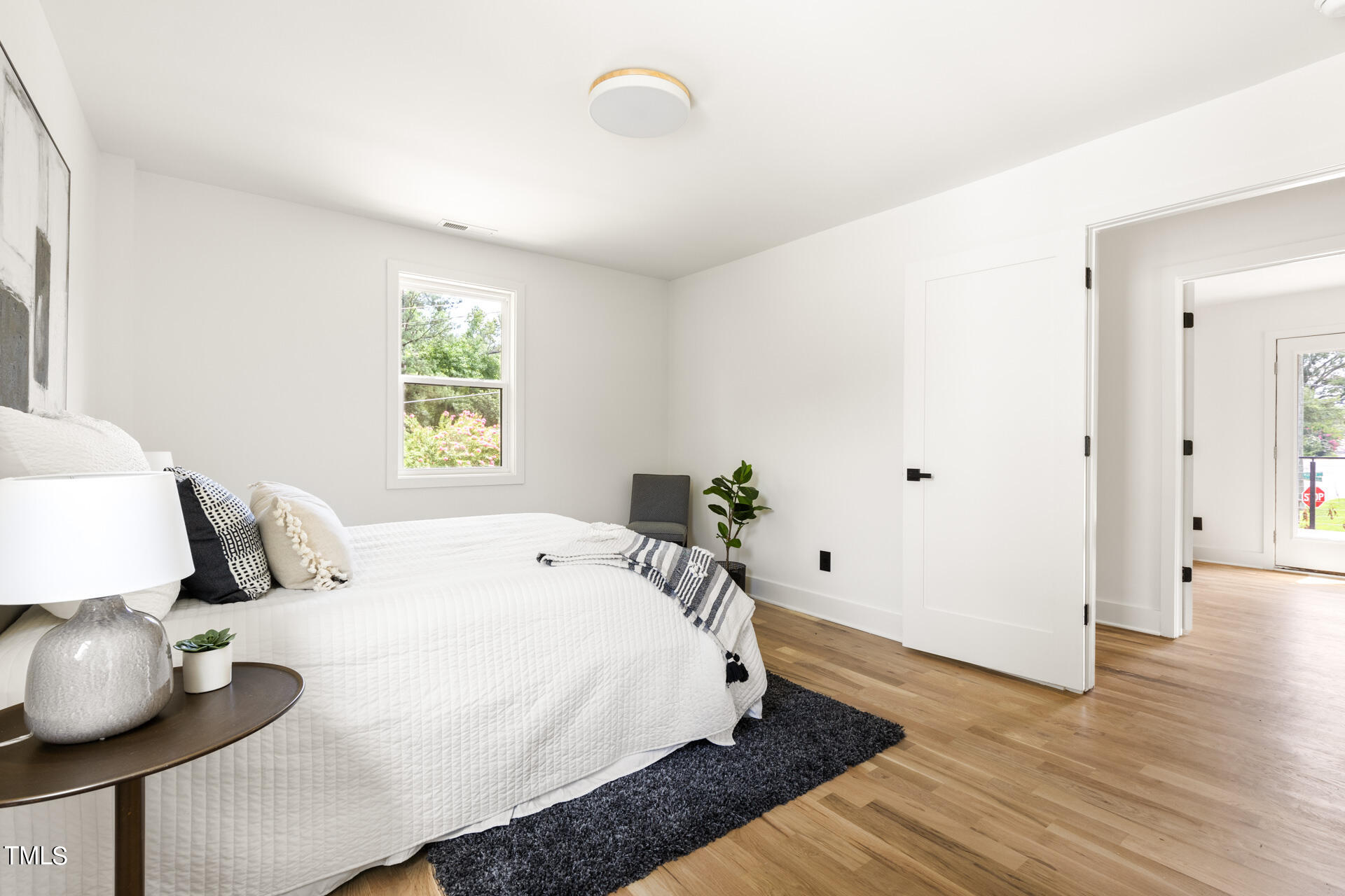 2909 Herring Boulevard Durham, NC 27704 - Photo 32 of 47 a bedroom with a bed and wooden floor