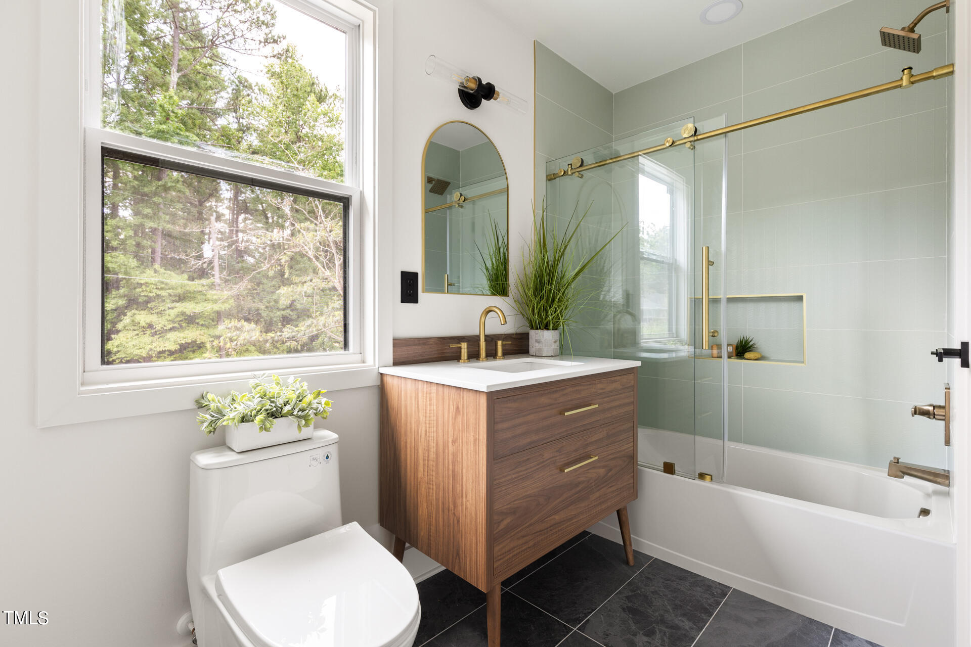 2909 Herring Boulevard Durham, NC 27704 - Photo 36 of 47 a bathroom with a tub sink toilet and a mirror