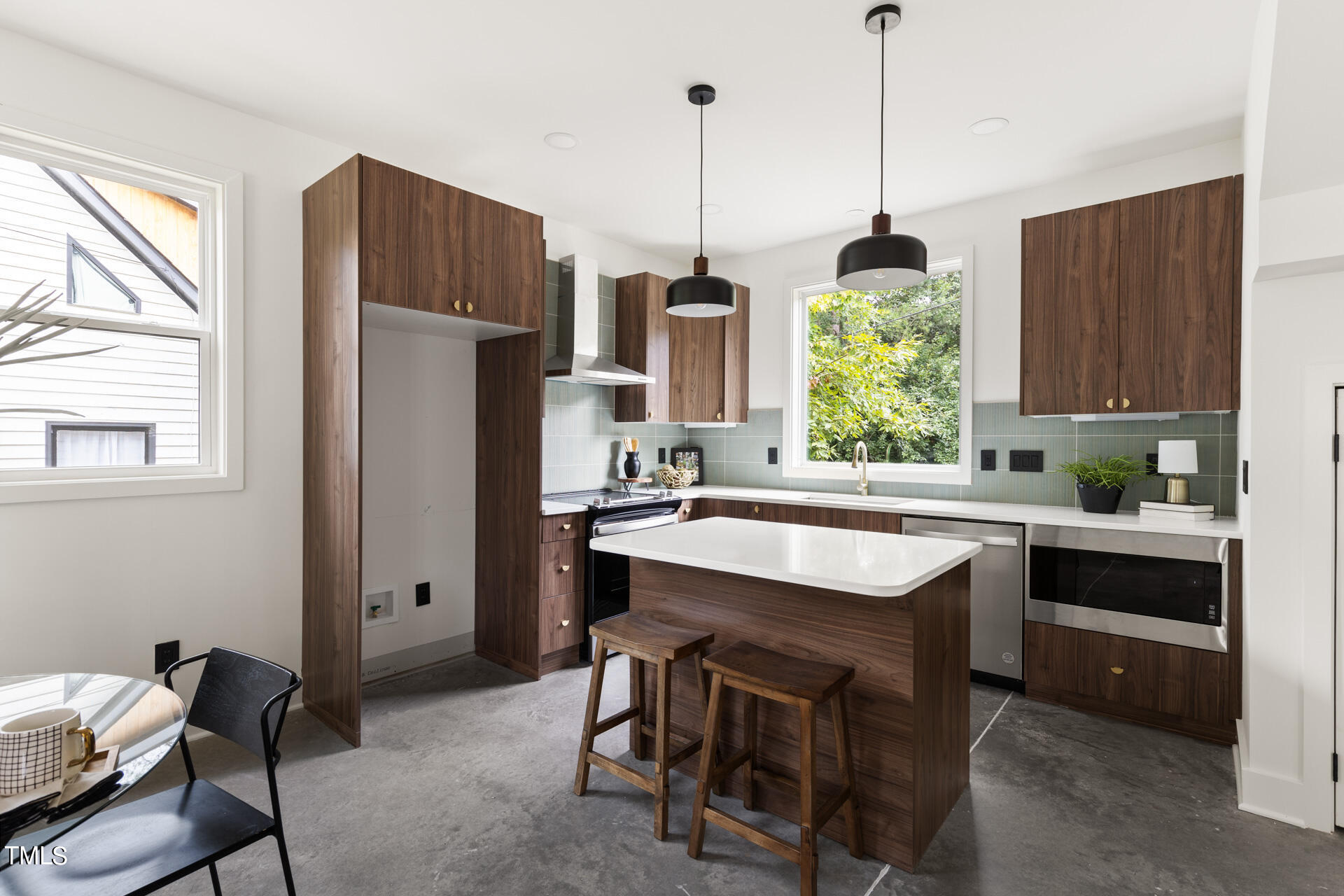 2909 Herring Boulevard Durham, NC 27704 - Photo 9 of 47 a kitchen with kitchen island a sink a center island and cabinets