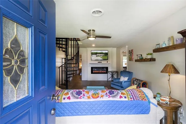 a bedroom with furniture and a window