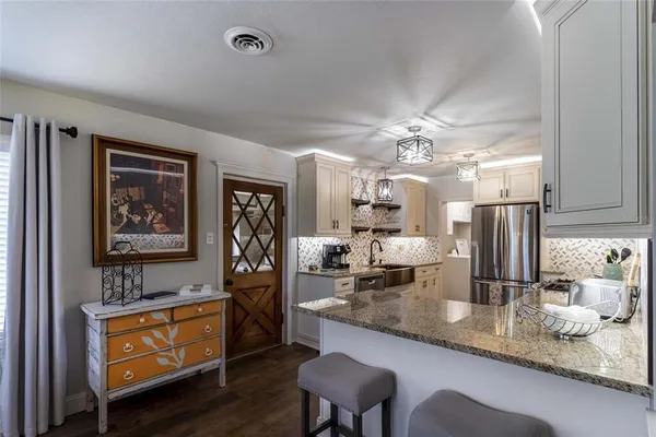 a living room with furniture a dining table and chairs with wooden floor