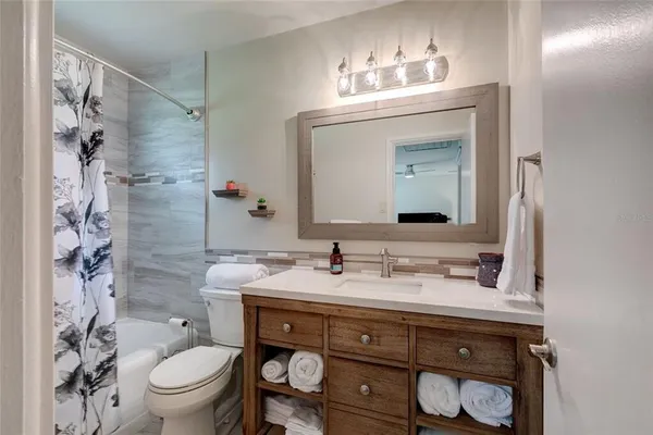 a bedroom with a bed couch and window