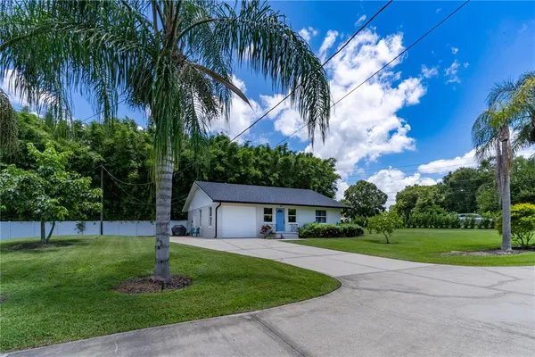 a living room with furniture a flat screen tv and a window
