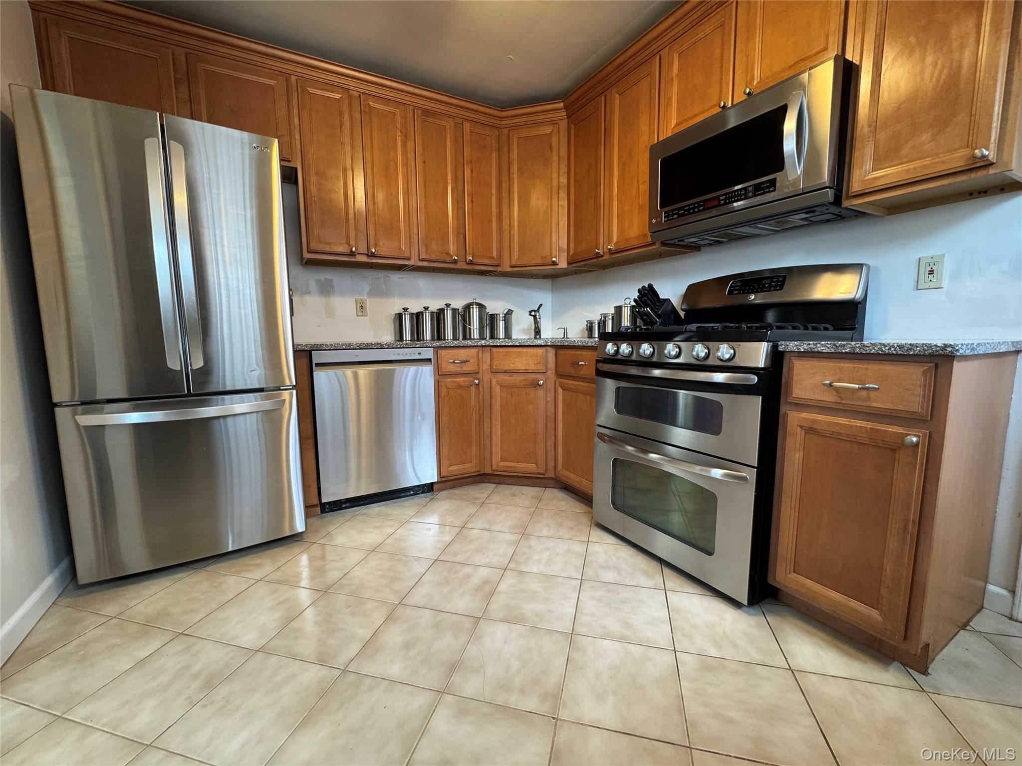 9 Valley Terrace Port Chester, NY 10573 - Photo 22 of 25 a kitchen with stainless steel appliances granite countertop a refrigerator stove top oven and microwave