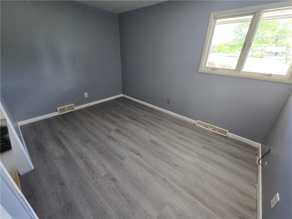 740 South Keel Ridge Road Hermitage, PA 16148 - Photo 13 of 33 an empty room with wooden floor and windows