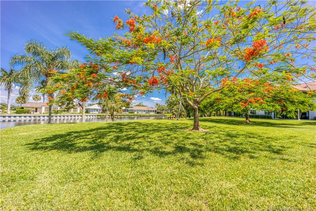 6101 Southeast Landing Way, Unit 5 Stuart, FL 34997 - Photo 11 of 13 a view of yard with swimming pool and trees