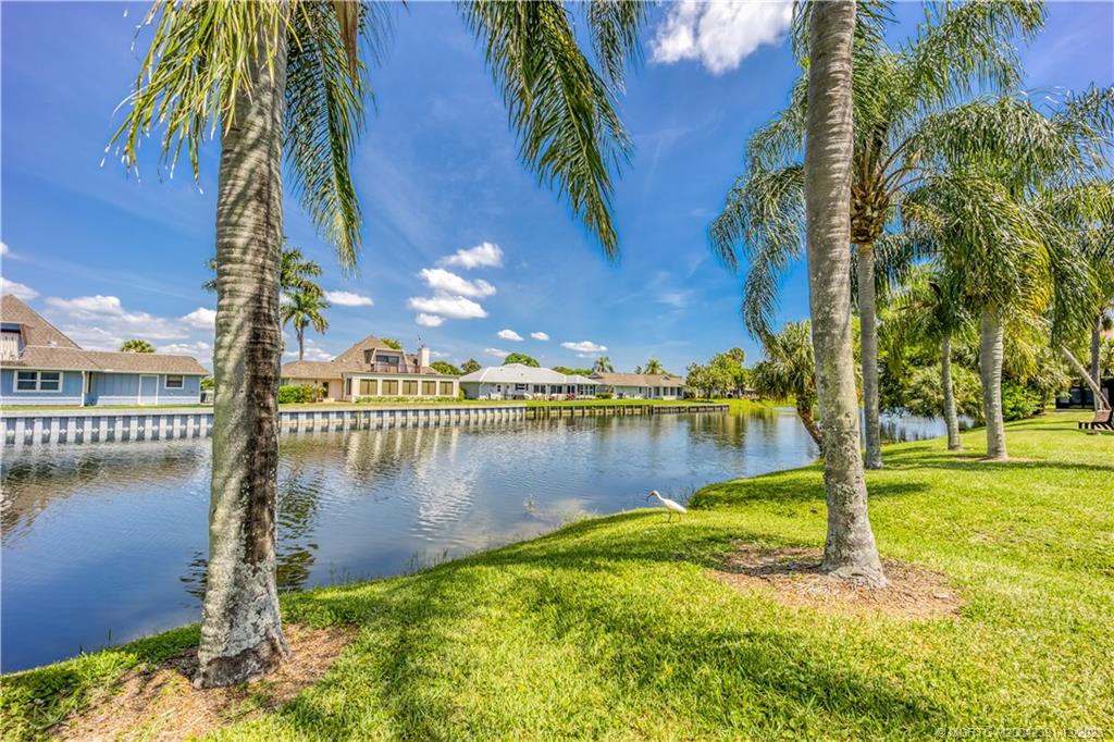 6101 Southeast Landing Way, Unit 5 Stuart, FL 34997 - Photo 12 of 13 a view of a lake with a big yard