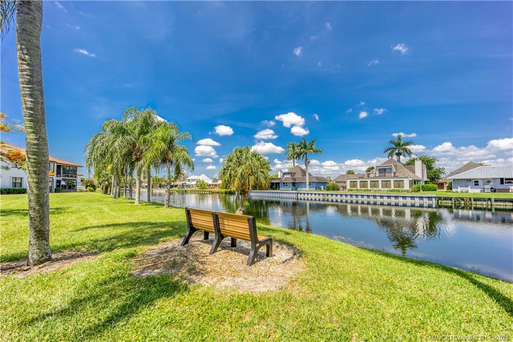 6101 Southeast Landing Way, Unit 5 Stuart, FL 34997 - Photo 13 of 13 a view of a lake with a patio