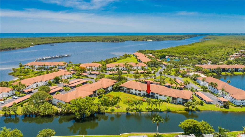 6101 Southeast Landing Way, Unit 5 Stuart, FL 34997 - Photo 2 of 13 an aerial view of residential houses with outdoor space and lake view