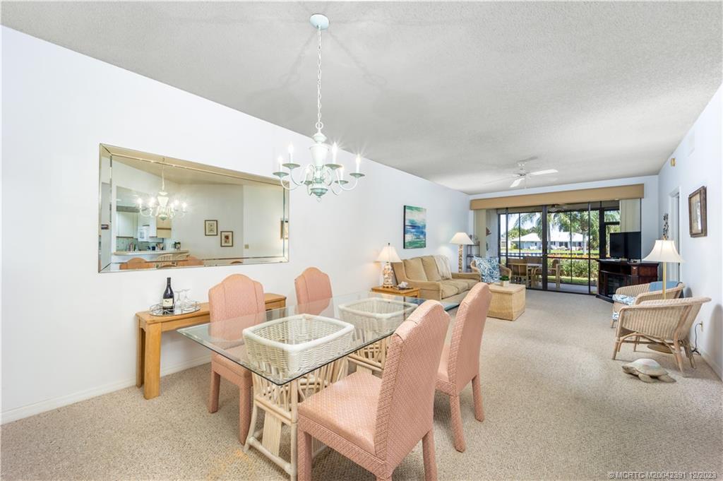 6101 Southeast Landing Way, Unit 5 Stuart, FL 34997 - Photo 3 of 13 a view of a dining room with furniture window and outside view