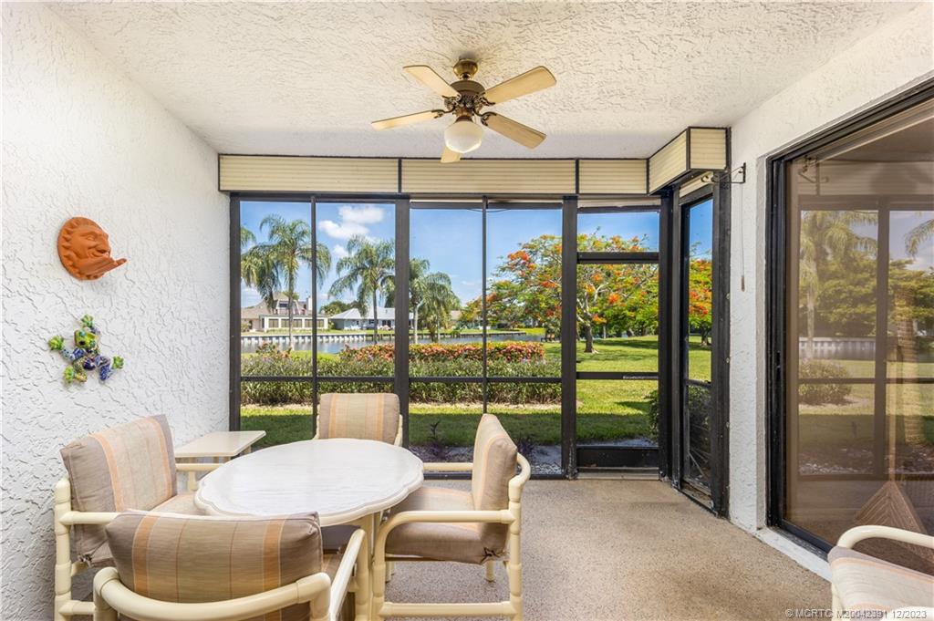 6101 Southeast Landing Way, Unit 5 Stuart, FL 34997 - Photo 4 of 13 a dining room with furniture and a floor to ceiling window