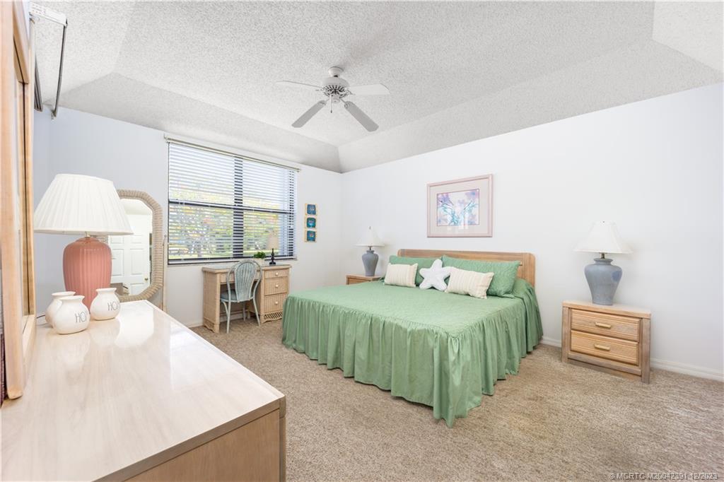 6101 Southeast Landing Way, Unit 5 Stuart, FL 34997 - Photo 8 of 13 a bedroom with a bed and a large window