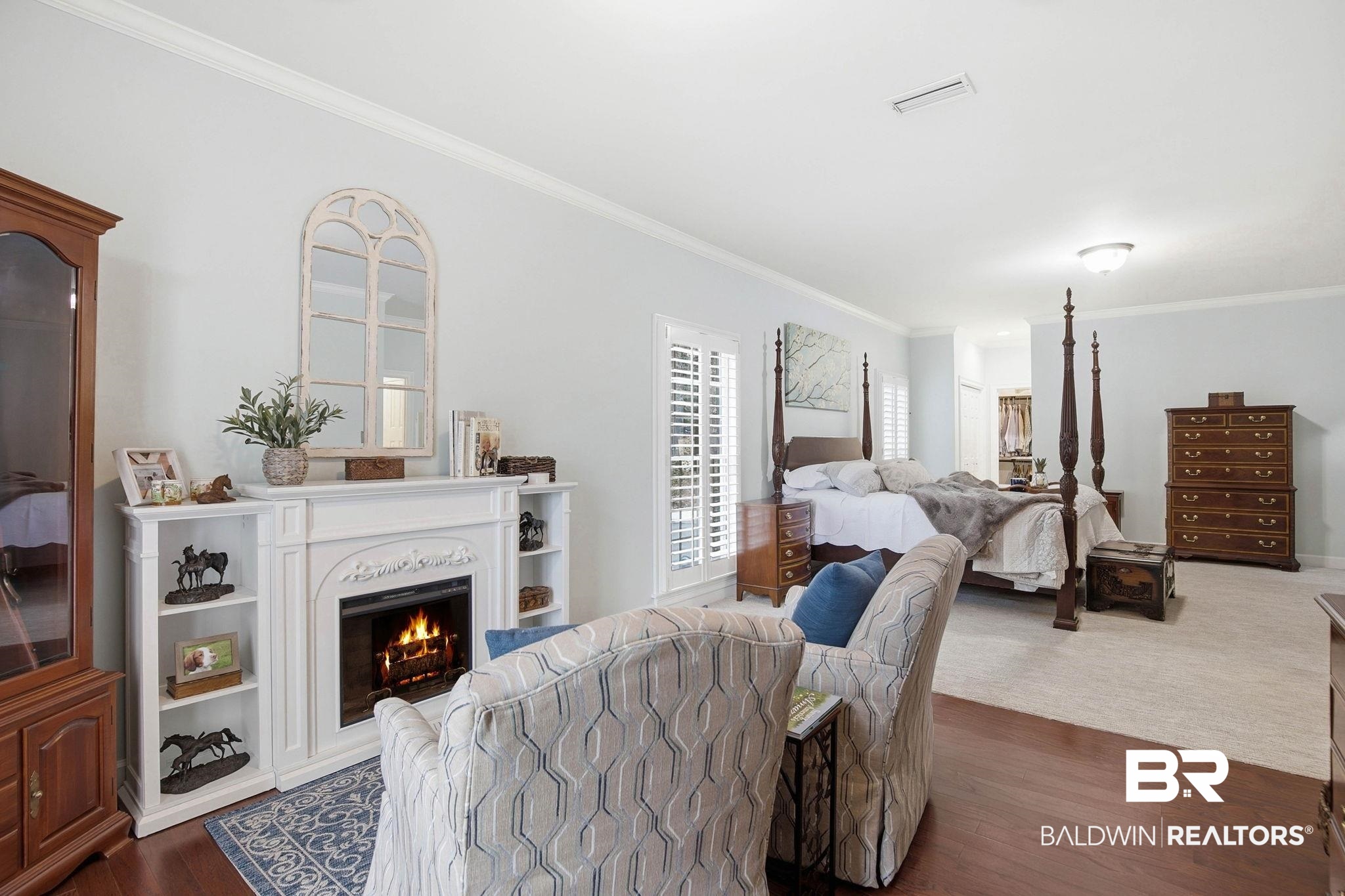 31515 Rhett Drive Spanish Fort, AL 36527 - Photo 33 of 100 The oversize primary suite has TWO walk in closets, a coat closet, a sitting area with an electric fireplace, crown molding, a large linen closet, and plantation shutters. The primary suite measures 16' 2" x 34' 6"