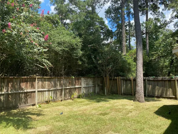 a swimming pool with trees in the background