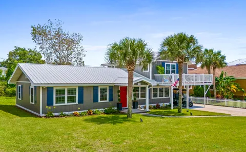 a view of a house with backyard porch and sitting area