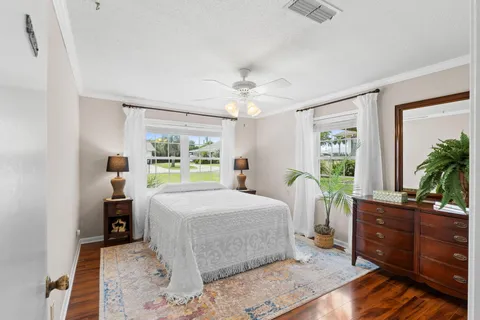 a bedroom with a large bed and a chandelier