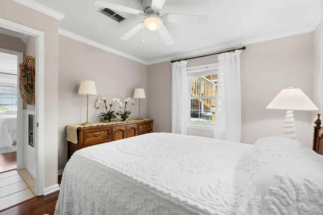 a spacious bedroom with a large bed and wooden floor