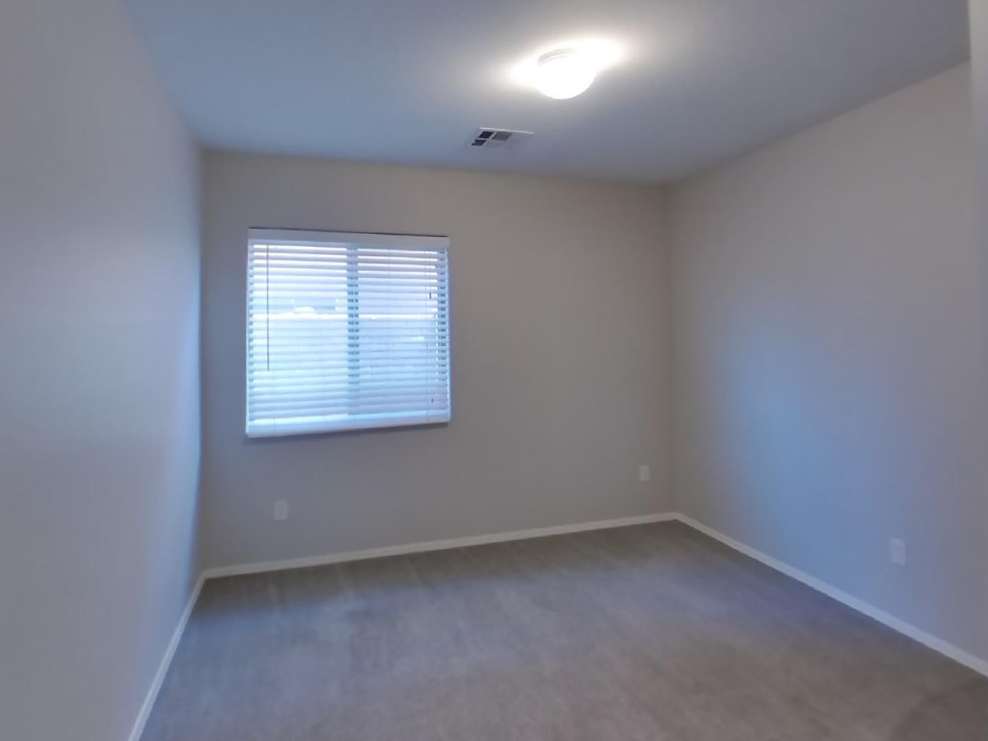 3194 West Tanner Ranch Road San Tan Valley, AZ 85144 - Photo 13 of 15 an empty room with a window