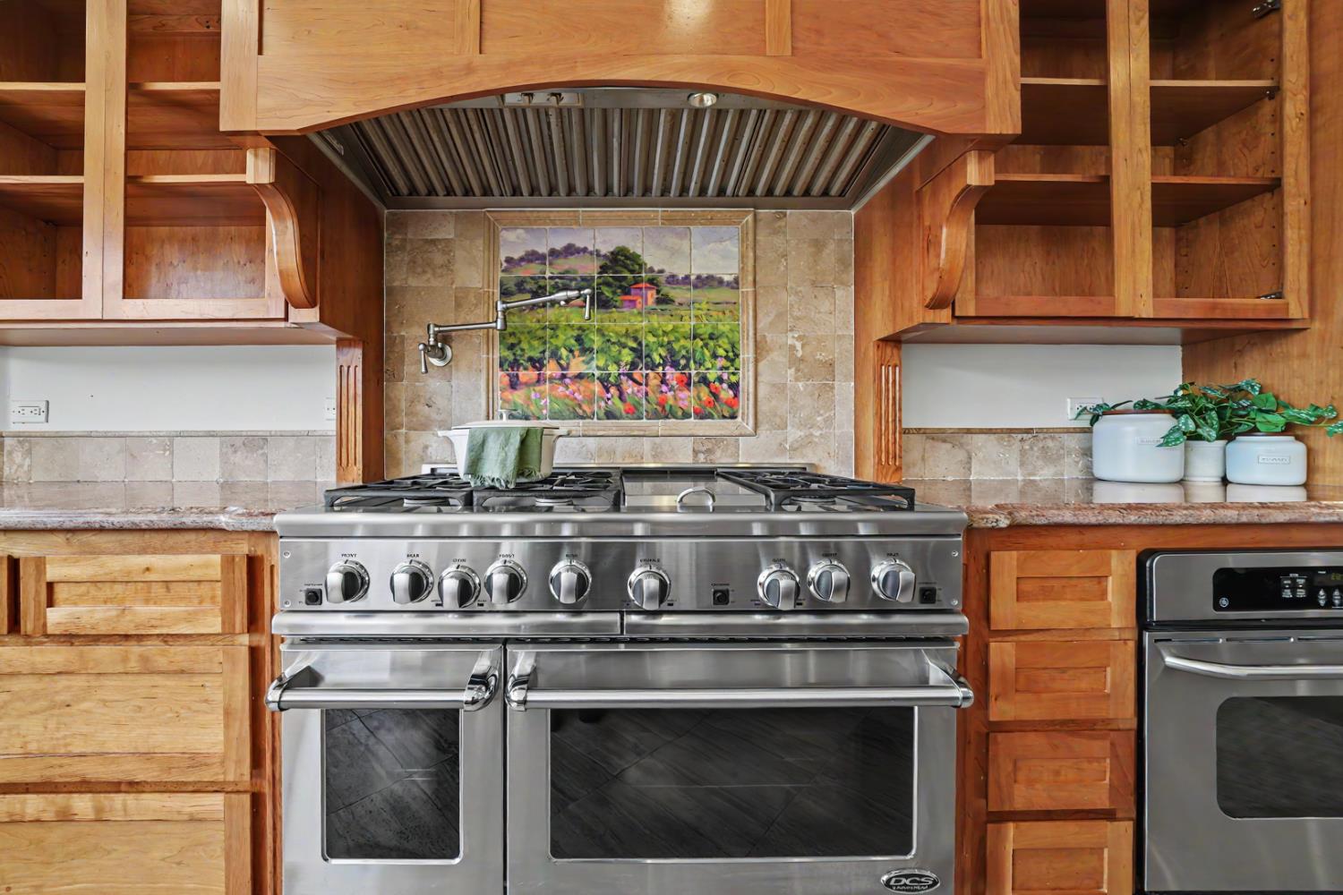 22930 Meadow View Road Fiddletown, CA 95629 - Photo 37 of 95 a kitchen with stainless steel appliances granite countertop a stove and a white cabinets