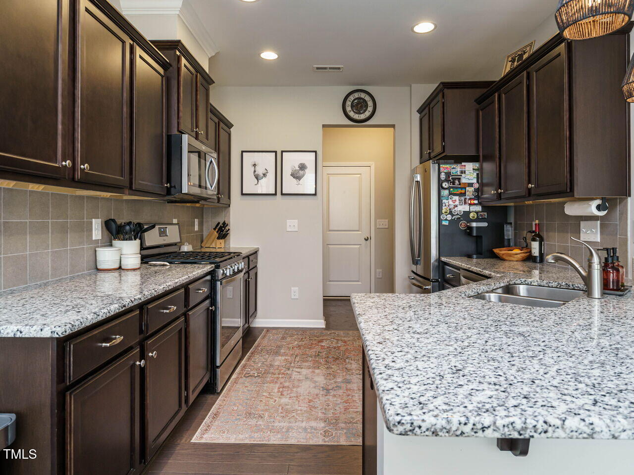 106 Zante Currant Road Durham, NC 27703 - Photo 11 of 27 a kitchen with stainless steel appliances granite countertop a sink stove and refrigerator