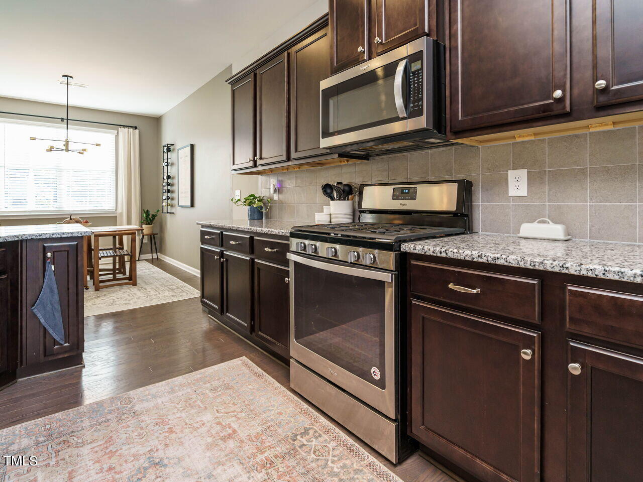 106 Zante Currant Road Durham, NC 27703 - Photo 13 of 27 a kitchen with stainless steel appliances granite countertop a stove a microwave and a sink