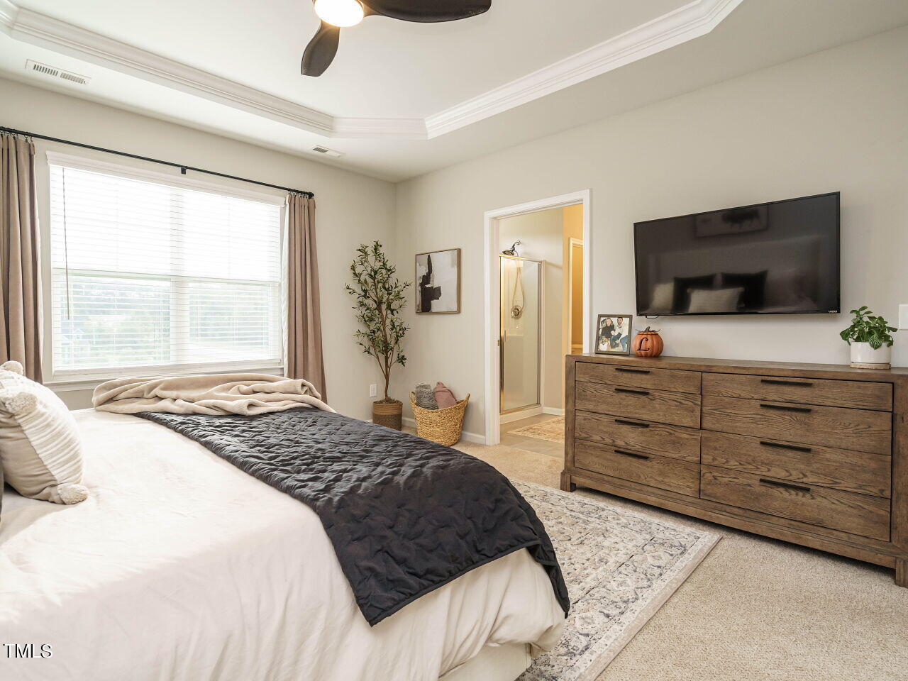 106 Zante Currant Road Durham, NC 27703 - Photo 18 of 27 a bedroom with a bed and a flat screen tv