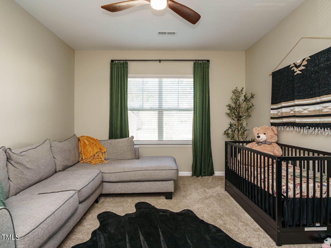 106 Zante Currant Road Durham, NC 27703 - Photo 22 of 27 a living room with a couch and a flat screen tv
