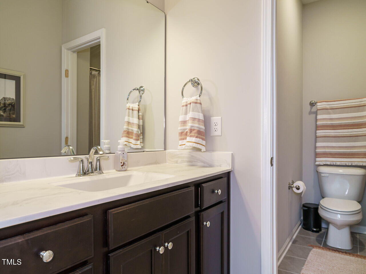 106 Zante Currant Road Durham, NC 27703 - Photo 23 of 27 a bathroom with a granite countertop sink a toilet and a mirror