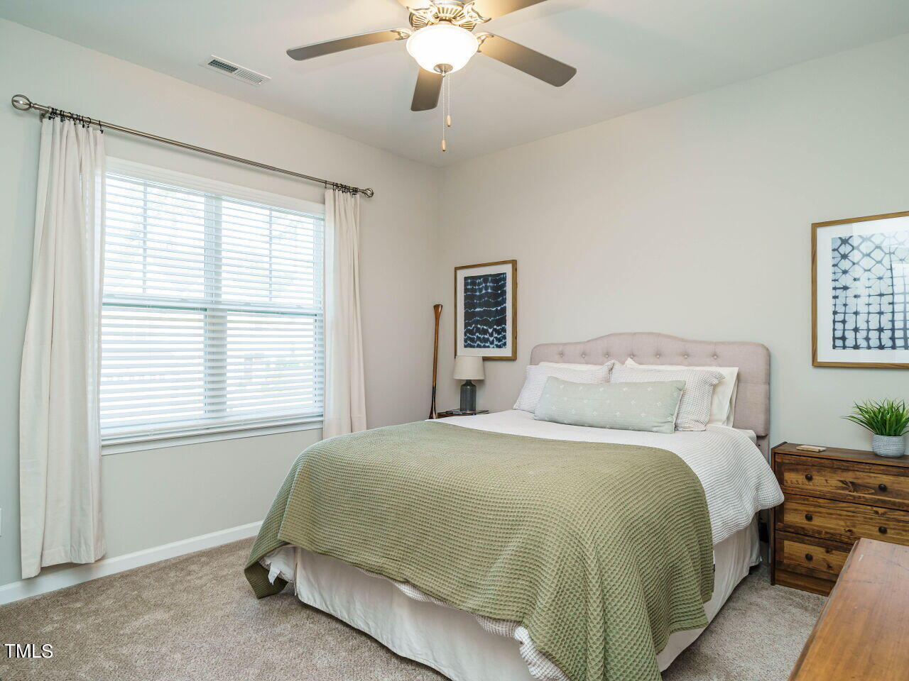 106 Zante Currant Road Durham, NC 27703 - Photo 24 of 27 a spacious bedroom with a bed and a chandelier