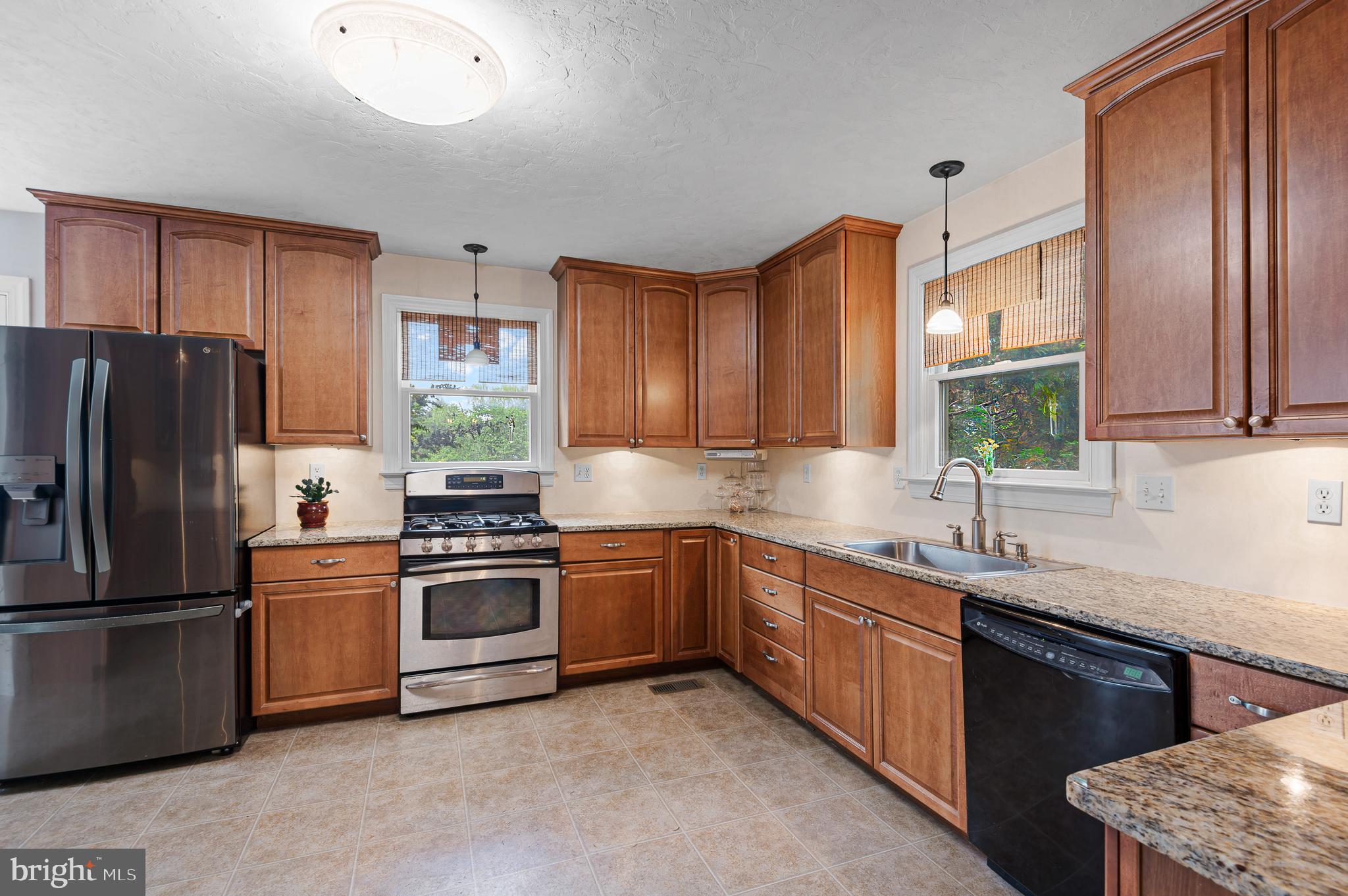 409 East Main Street Westminster, MD 21157 - Photo 14 of 46 a kitchen with stainless steel appliances granite countertop a sink stove and refrigerator