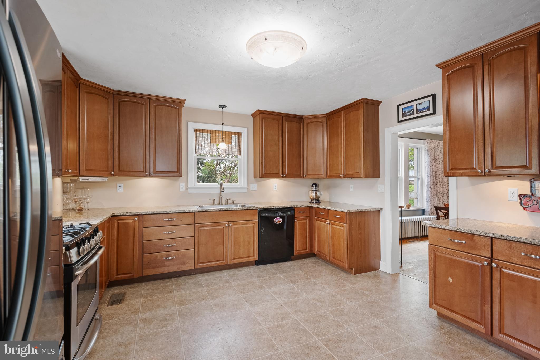 409 East Main Street Westminster, MD 21157 - Photo 15 of 46 a kitchen with stainless steel appliances granite countertop wooden cabinets a stove top oven a sink and dishwasher