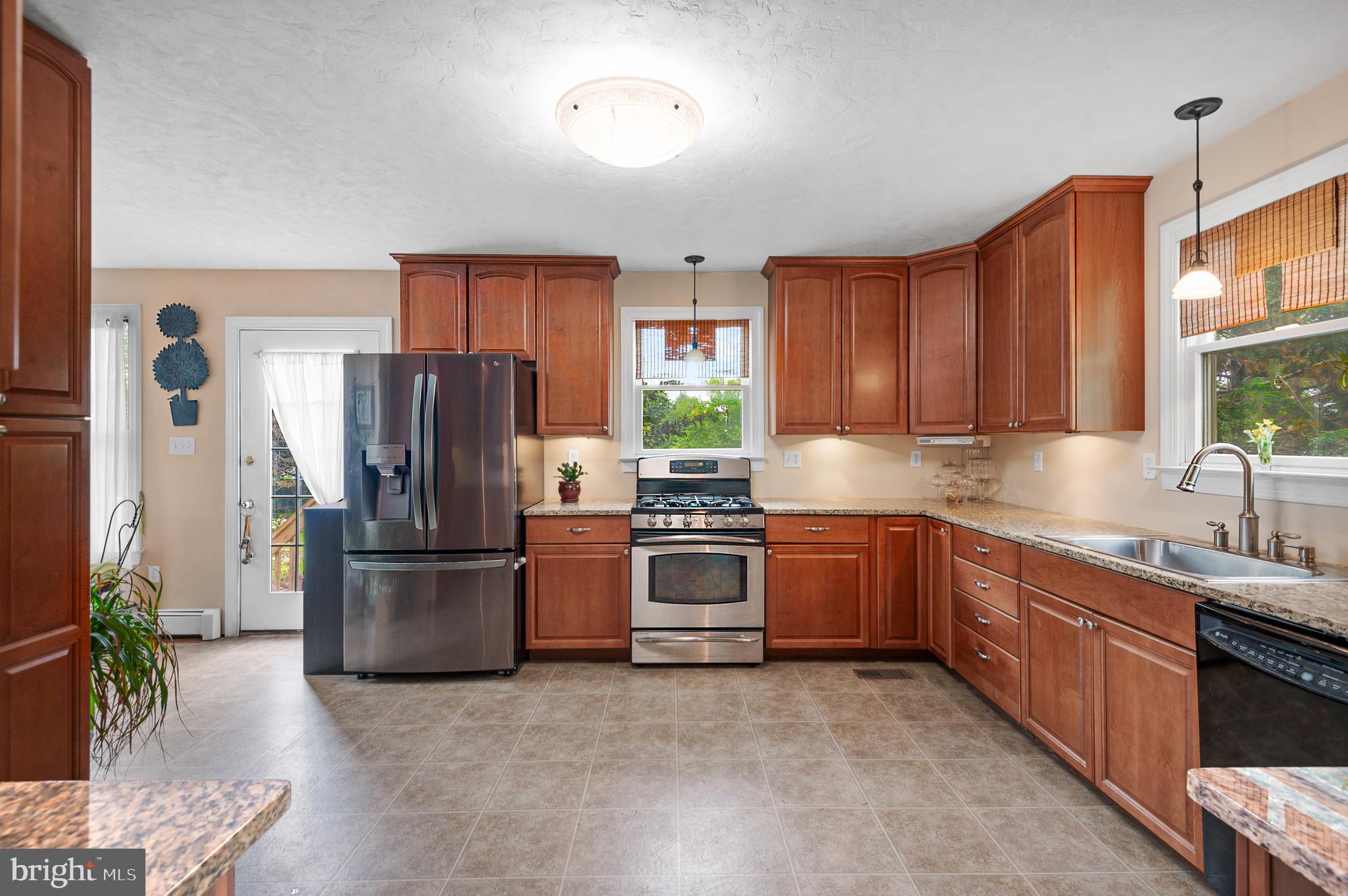 409 East Main Street Westminster, MD 21157 - Photo 17 of 46 a kitchen with refrigerator a microwave a sink and a stove