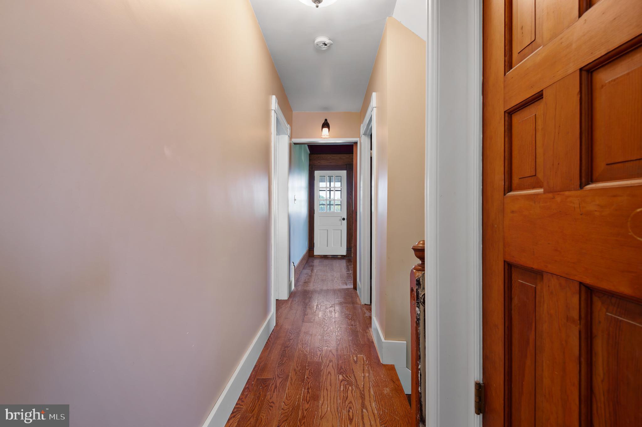 409 East Main Street Westminster, MD 21157 - Photo 25 of 46 a view of a hallway with wooden floor and staircase
