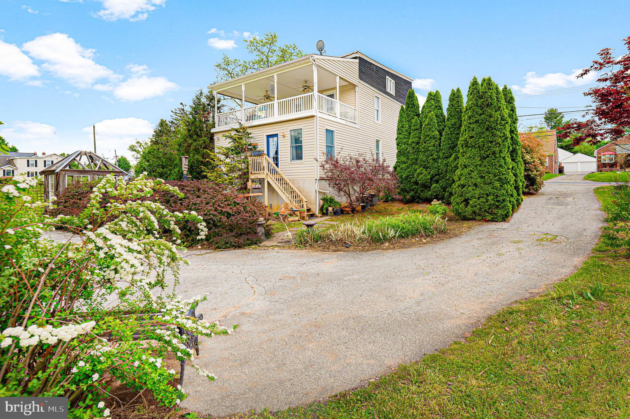 409 East Main Street Westminster, MD 21157 - Photo 32 of 46 a front view of a house with a yard and potted plants