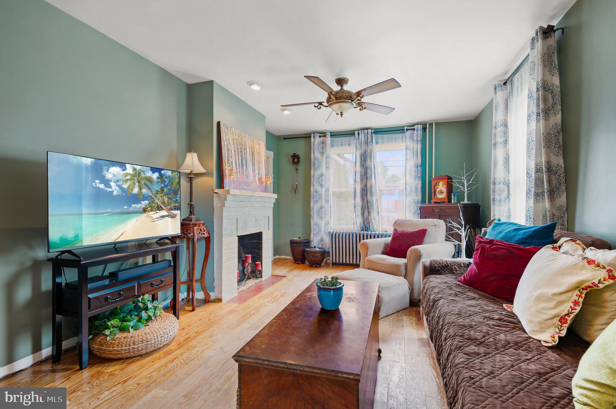 409 East Main Street Westminster, MD 21157 - Photo 6 of 46 a living room with fireplace furniture and a flat screen tv