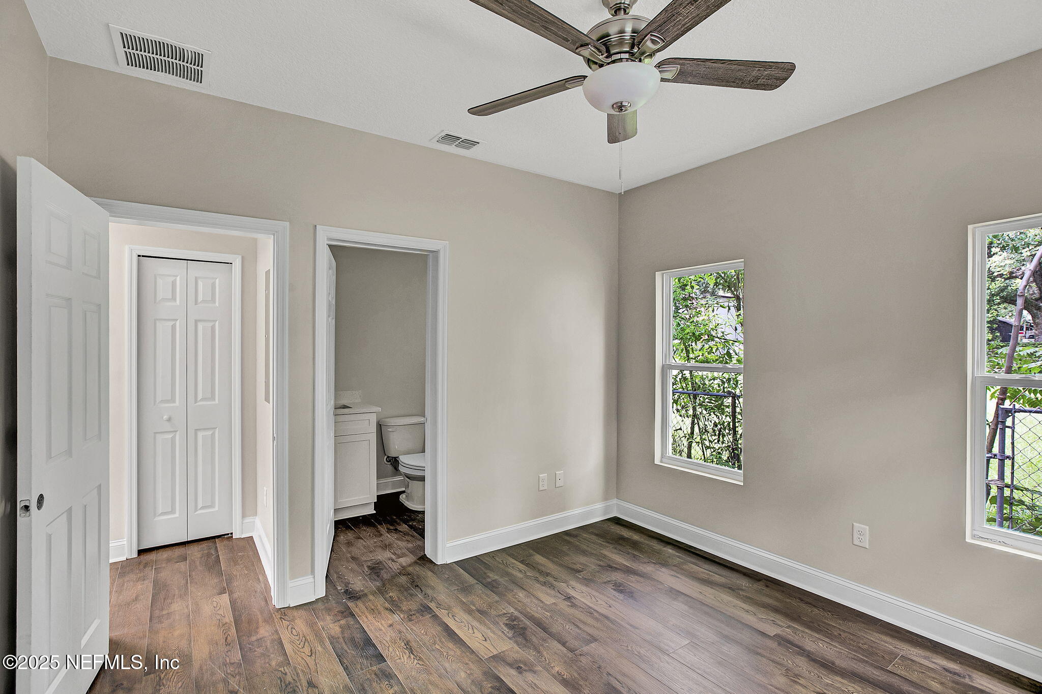 2291 Clemente Drive Jacksonville, FL 32204 - Photo 13 of 20 wooden floor in an empty room with a window