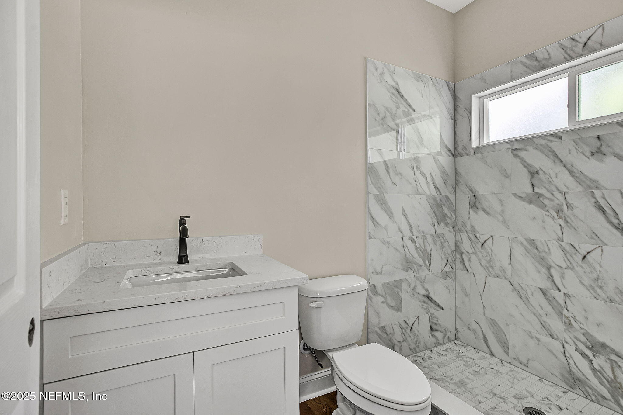 2291 Clemente Drive Jacksonville, FL 32204 - Photo 14 of 20 a bathroom with a toilet sink and window