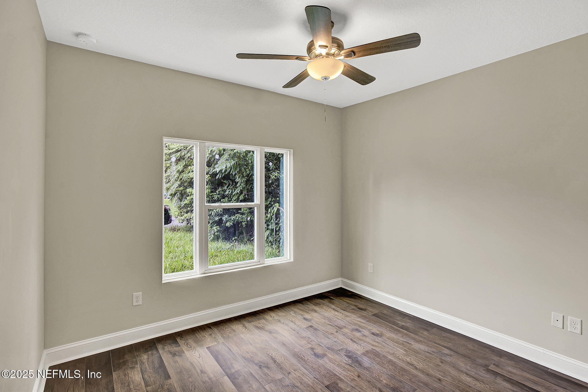 2291 Clemente Drive Jacksonville, FL 32204 - Photo 18 of 20 an empty room with a window and a fan