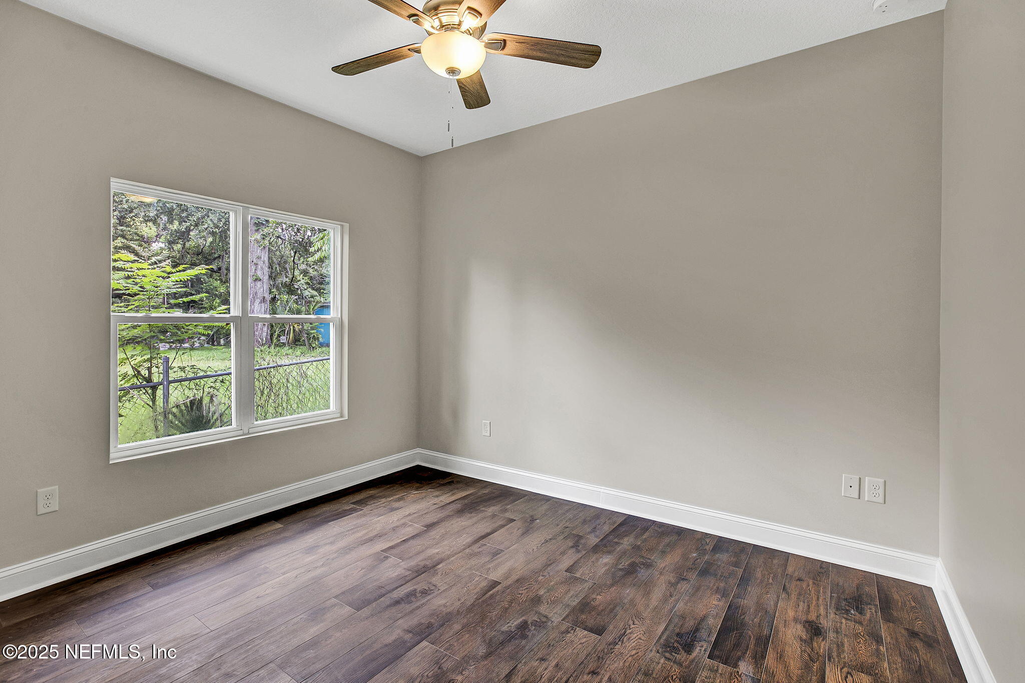 2291 Clemente Drive Jacksonville, FL 32204 - Photo 19 of 20 an empty room with wooden floor and windows