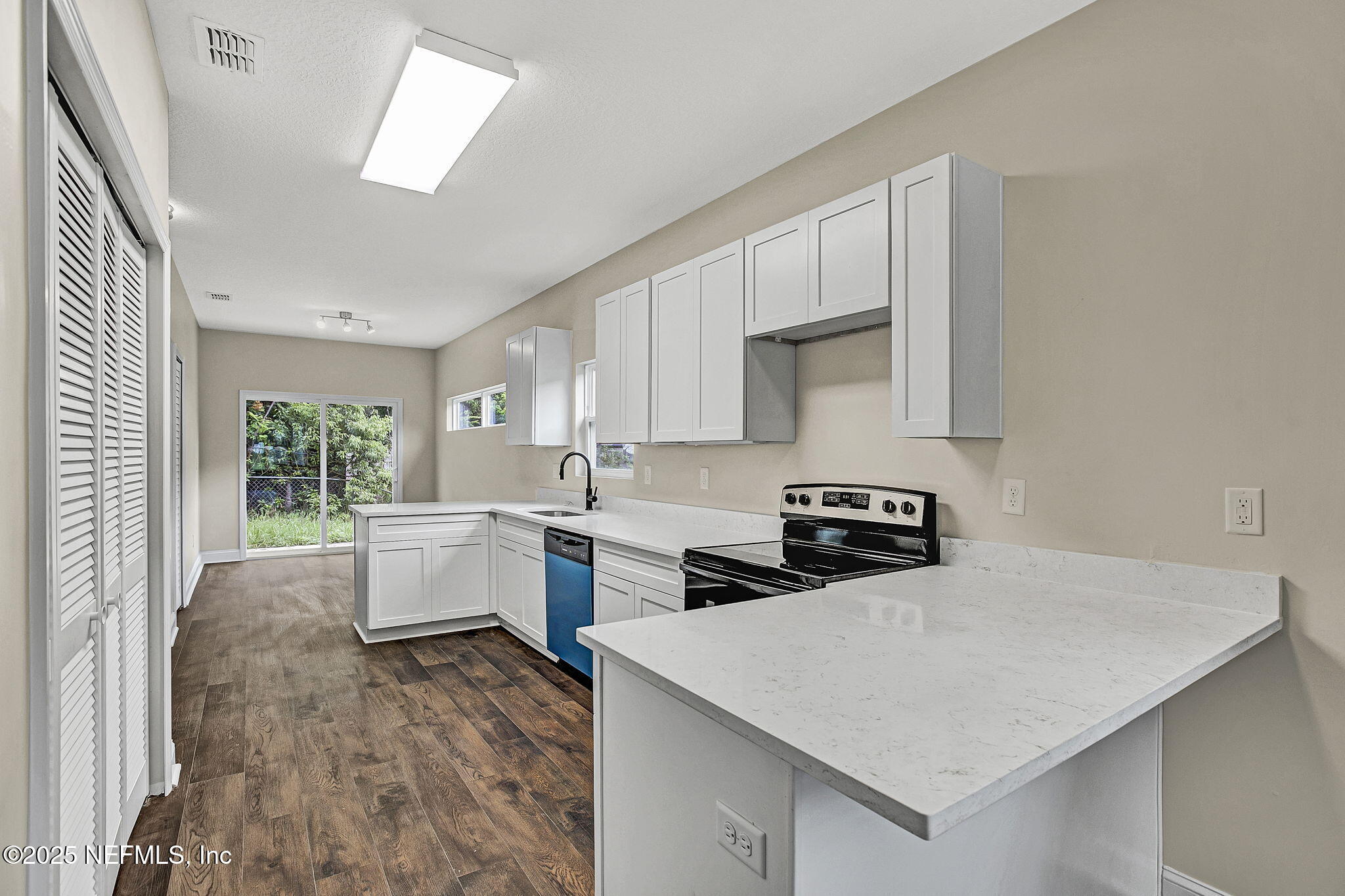 2291 Clemente Drive Jacksonville, FL 32204 - Photo 8 of 20 a kitchen with a stove a sink and a refrigerator