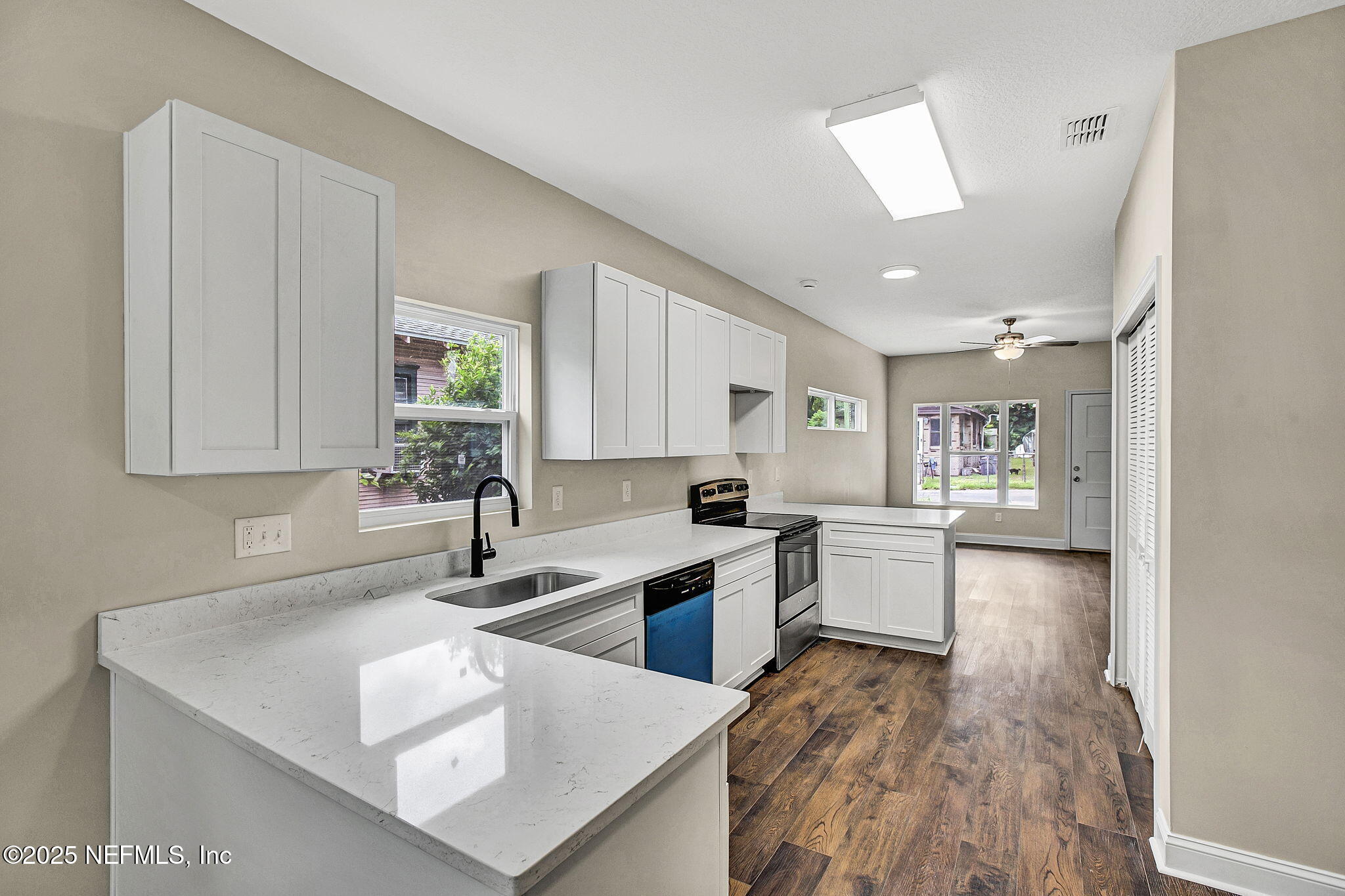 2291 Clemente Drive Jacksonville, FL 32204 - Photo 10 of 20 a kitchen with a sink a counter top space and living room area