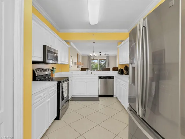a kitchen with a sink cabinets and appliances
