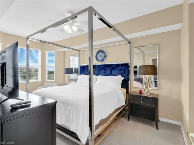 a bed room with a bed and a large window