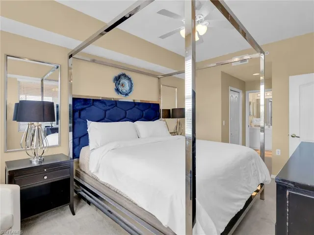 a bedroom with a bed and a lamp on table