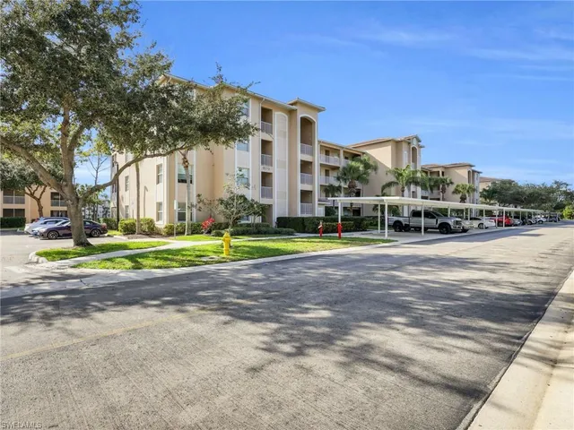 a view of a white house with a yard