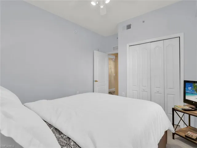 a large white bed in a white room