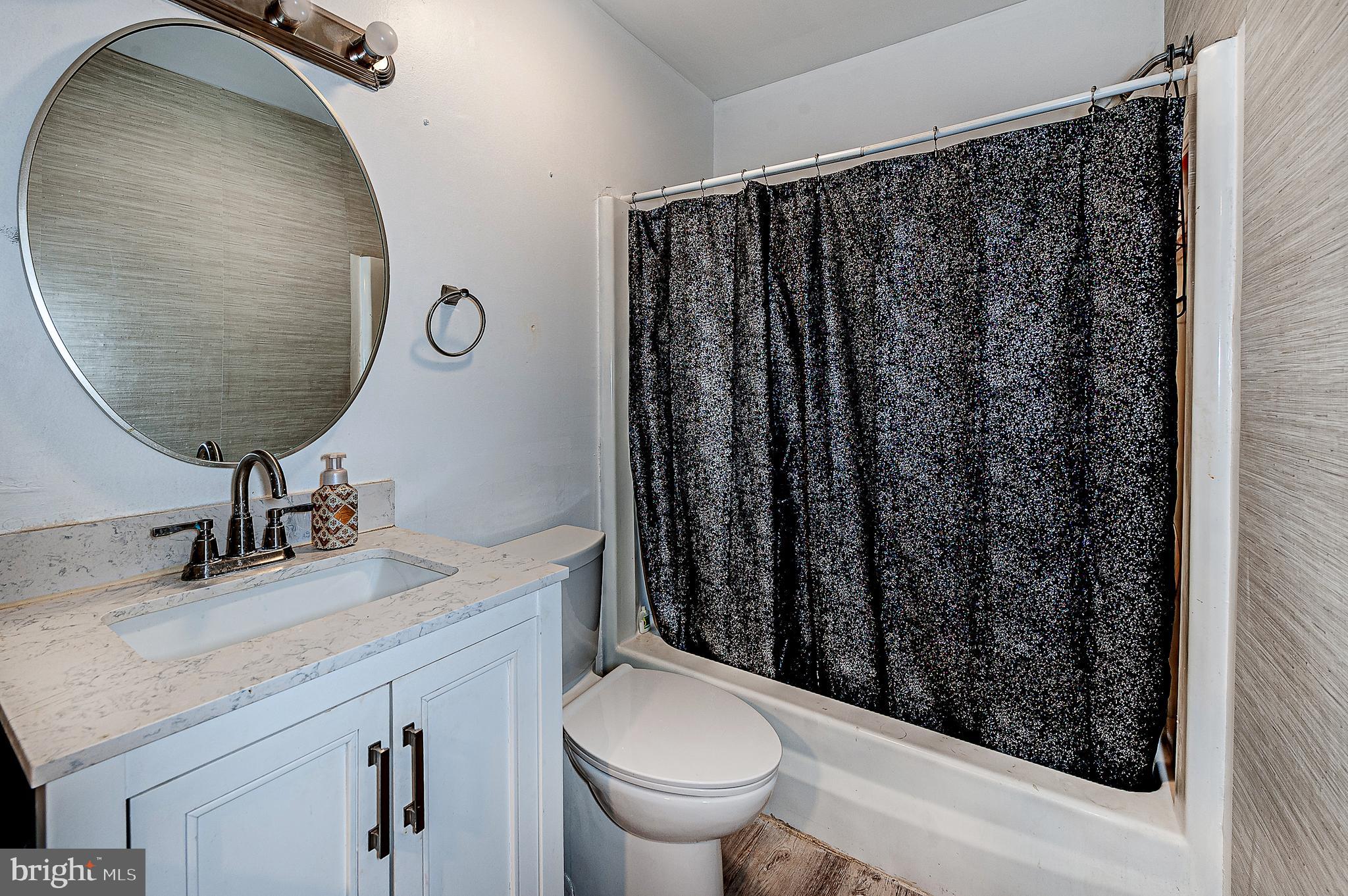 808 Winding Way Westville, NJ 08093 - Photo 12 of 14 a bathroom with a granite countertop toilet sink and mirror