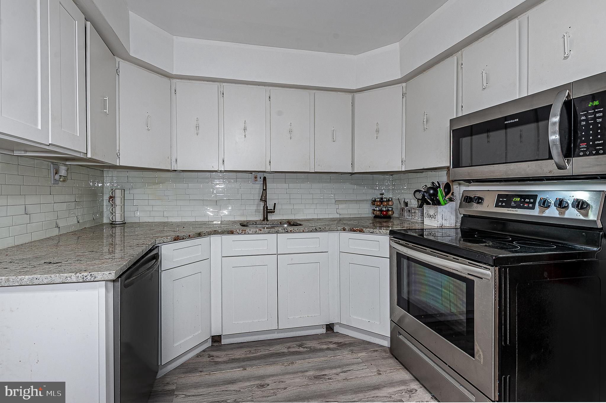 808 Winding Way Westville, NJ 08093 - Photo 8 of 14 a kitchen with stainless steel appliances granite countertop a sink stove and microwave